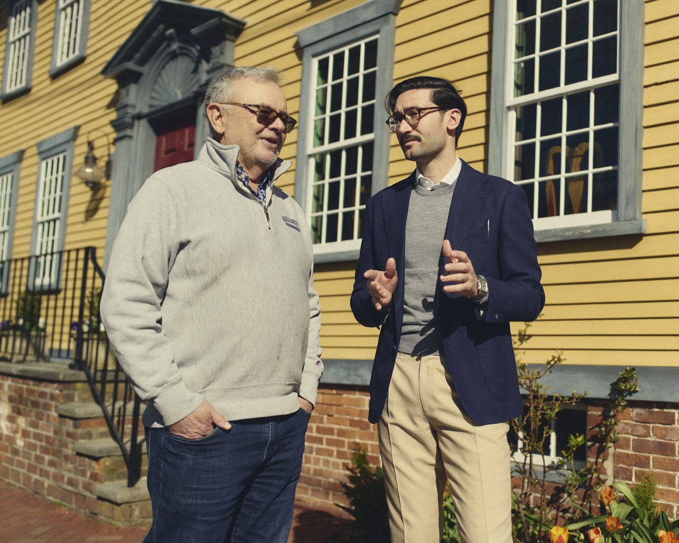 Rob Craven speaking with a neighbor outside a historic Wickford home